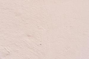 Texture of a concrete wall with cracks and scratches which can be used as a background photo