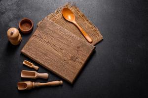 An empty wooden cutting board with wooden cutlery
