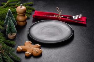 An empty wooden cutting board with wooden cutlery on a christmas kitchen table photo