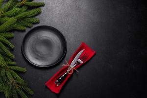 An empty wooden cutting board with wooden cutlery on a christmas kitchen table photo