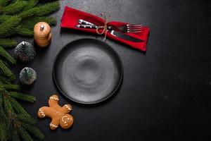 An empty wooden cutting board with wooden cutlery on a christmas kitchen table photo