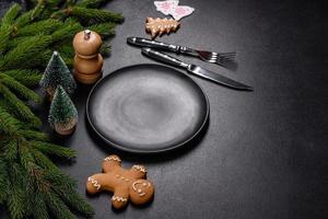 An empty wooden cutting board with wooden cutlery on a christmas kitchen table photo