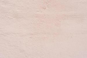 Texture of a concrete wall with cracks and scratches which can be used as a background photo