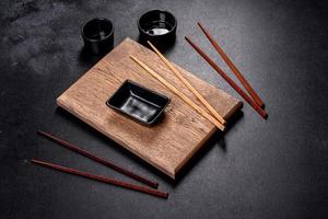 Wooden sushi sticks on a dark concrete background