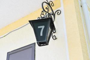 house number sign in a shape of old streetlight photo