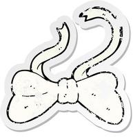 retro distressed sticker of a cartoon bow tie vector