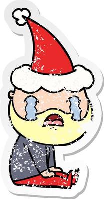distressed sticker cartoon of a bearded man crying wearing santa hat