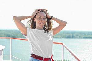 beautiful woman holding her hair blowing by the wind photo