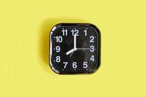 alarm clock on yellow background. photo