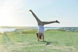 toned fit woman of mid age turning handsprings photo