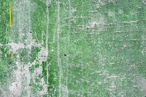 Texture of a concrete wall with cracks and scratches which can be used as a background photo