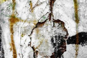 Texture of a concrete wall with cracks and scratches which can be used as a background photo