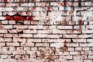 Weathered texture of stained old dark white and orange brick wall background photo