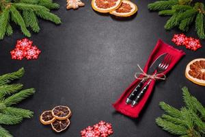 Festive Christmas table with appliances, gingerbreads, tree branches and dried citrus trees photo