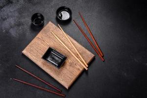 Wooden sushi sticks on a dark concrete background