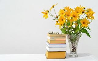 back to school concept. orange flowers in a vase photo