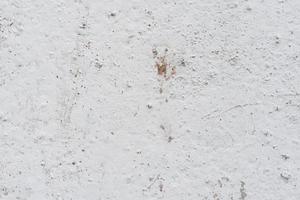 Texture of a concrete wall with cracks and scratches which can be used as a background photo