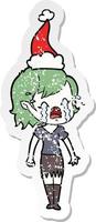 distressed sticker cartoon of a crying vampire girl wearing santa hat vector