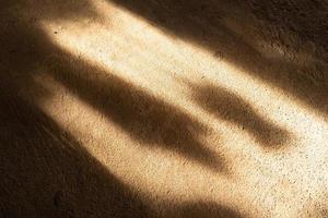 Light and shadow falling on the brown concrete floor. use for background photo