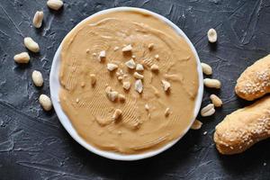 american traditional peanut butter with salted peanuts. photo