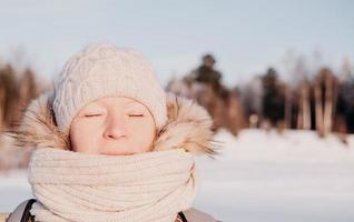 middle age woman relaxing under winter sun. photo