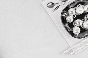 Christmas table setting. Christmas tree balls on a black plate photo