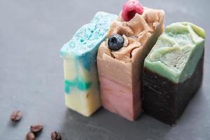 three bars of hand made organic soap for spa relax routine. exfoliating soap with various components for smoth and healthy body skin photo