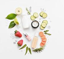 organic cosmetics with eatable ingredients. cucumber, carrot and strawberry as cream and serum components. home grown cosmetics. flat lay photo