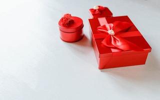 Red gift box on white wooden background photo