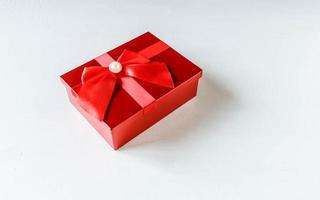 Red gift box on white wooden background photo