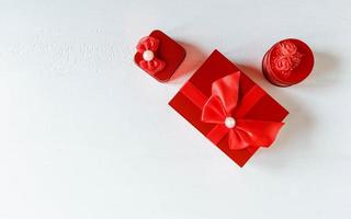 Red gift box on white wooden background photo