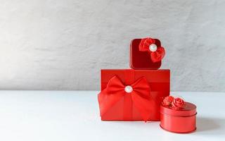 Red gift box on white wooden background photo