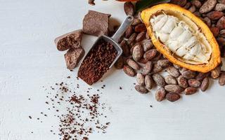 Half cacao pods with cacao fruit and brown cocoa    powder photo