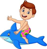 Cartoon little boy riding a inflatable shark vector