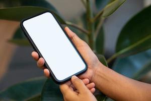 woman's hand holding a phone with a white photo