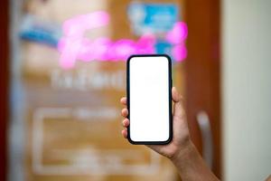 woman's hand holding a phone with a white photo