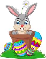 Cartoon bunny in the pot with easter eggs on the grass vector