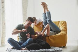 Modern technologies. Young couple with kid looking together at the pictures maked by camera photo