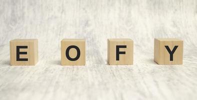 EOFY, End of Financial Year text. wood cubes and white background photo