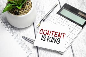 CONTENT IS KING text on sticker with calculator, glasses and magnifier photo