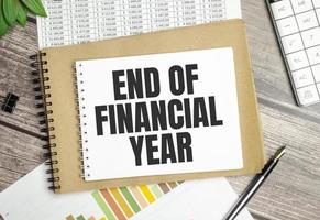Text End of Financial Year on a notebook on the diagram and charts with calculator and pen photo
