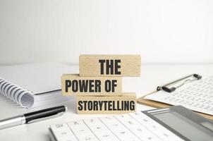 the power of storytelling - text on wooden blocks on dark grey background. photo