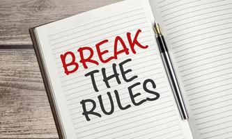 break the rules text on notepad with pen, business concept photo