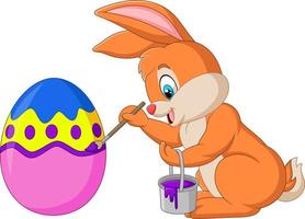 Easter bunny painting an egg vector