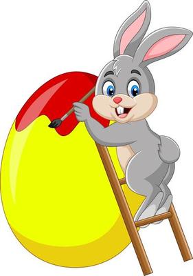 Easter bunny painting an egg