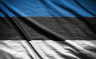 Realistic flag of  estonia on the wavy surface of fabric photo