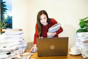 Businesswoman standing and working at her desk at home. Workaholic people concept photo