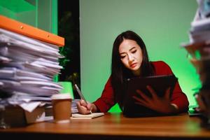 A Female employee remote works at home by digital tablet. Workaholic people concept photo