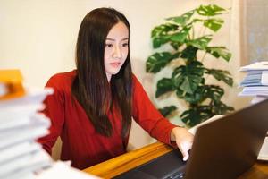 Workaholic people concept. Asian woman doing overtime at home office, late time business. photo