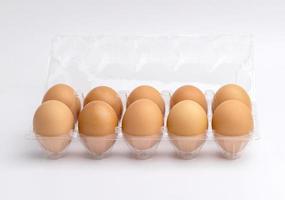 Eggs in a plastic box on the white background photo